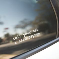 the back window of a car that says tell your cat, i said popss