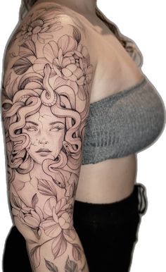 a woman's arm with flowers on it and a face in the middle of her arm