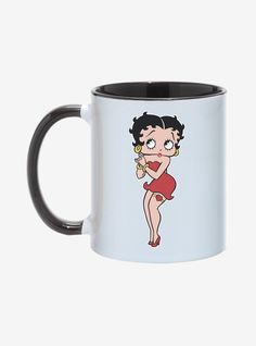 a black and white coffee mug with an image of a woman in a red dress