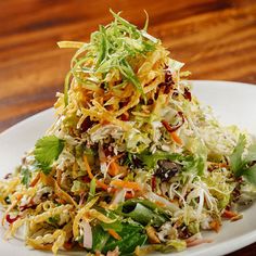 a white plate topped with a pile of salad