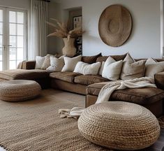 a living room filled with lots of furniture and pillows