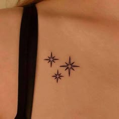 the back of a woman's shoulder with three stars on it