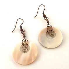 A clear brown colored bead wrapped around a natural shell disk with bronze colored wire. Antique copper ear wires. Horn Diy, Bronze Earrings, Beaded Wraps, Bronze Color, Antique Copper, Ear Wires, Wire Wrapped, Horn, Wire Wrapping