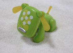 a green toy with white dots on it