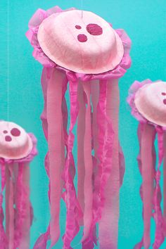 the jellyfish paper plate craft is made with pink tissue pom - poms