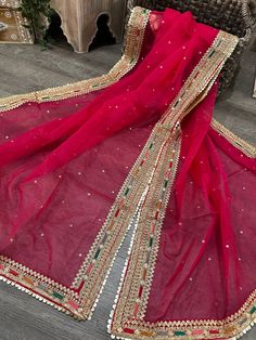 Sheer and lightweight hot pink organza dupatta with mutlicolor embroidery on gold border. Luxury Sheer Dupatta Embroidered Dola Silk Fabric, Cheap Embroidered Dupatta For Puja, Luxury Pink Dupatta With Zari Weaving, Pink Organza Dupatta, Pink Dupatta, Rani Pink, Gold Border, Organza Dupatta, Gold Threads