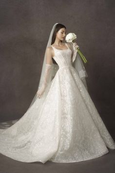 a woman in a wedding dress holding flowers