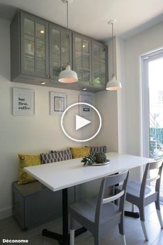 a white table and some chairs in a room