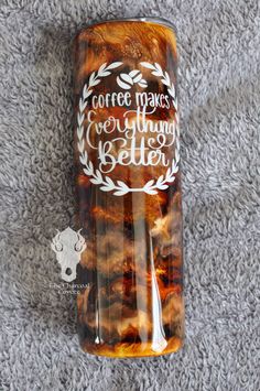 a glass bottle that says coffee makes everything better on the inside, sitting on a carpet