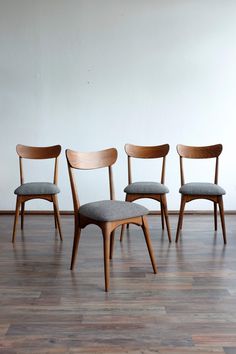 four chairs sitting on top of a hard wood floor