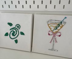 two embroidered napkins with designs on them sitting on a shelf next to each other