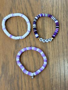 This a great set of 3 purple bracelets for anyone of any age. It's also a great gift for friends or family! Handmade using clay beads. If you want custom colors, please send me a message. Happy to discuss ideas. Purple Friendship Bracelets With Letter Beads, Hypoallergenic Purple Friendship Bracelets, Adjustable Purple Heishi Beads Bracelets, Purple Heishi Beaded Bracelets With Letter Beads, Purple Heishi Beads Bracelet With Letter Beads, Purple Clay Bead Bracelet Ideas, Purple Bracelet Ideas, Purple Clay Bead Bracelet, Trio Bracelets