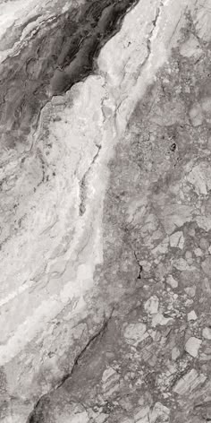 a black and white photo of marble with water running down the side, as seen from above