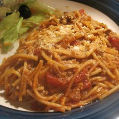 a plate with spaghetti and salad on it