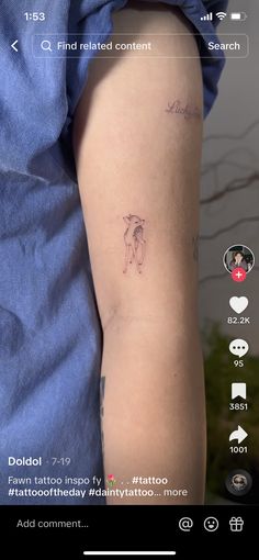 a person with a tattoo on their arm is looking at the camera and it's screen