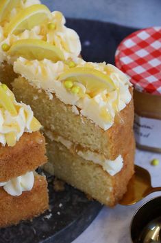 a piece of cake with white frosting and lemon slices