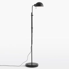 a black floor lamp with a white light on the side and a cord attached to it