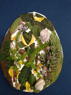 a plate with plants and seashells on it