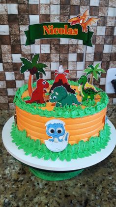 a birthday cake decorated with animals and plants