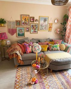 a living room filled with lots of furniture and pictures hanging on the wall above it