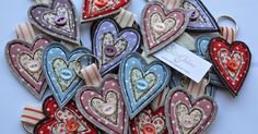 several heart shaped ornaments are displayed on a white surface with a tag in the middle