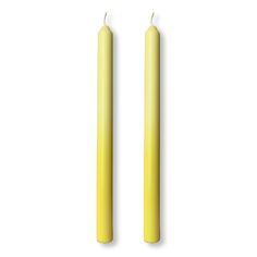 two yellow candles sitting next to each other