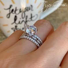 a close up of a person's hand with a wedding ring on their finger