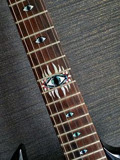 an electric guitar with all seeing eyes on it