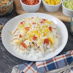 a white plate topped with rice covered in toppings