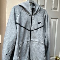 Nike Tech Hoodie New With Tag Gray Fleece Hooded Jacket For Streetwear, Nike Gray Hooded Hoodie, Gray Nike Hoodie For Outdoor, Nike Hoodie In Athletic Heather For Winter, Nike Winter Hoodie In Athletic Heather, Nike Gray Hooded Sweatshirt, Sporty Gray Fleece Hoodie, Nike Athletic Heather Hoodie For Winter, Nike Gray Hoodie For Streetwear