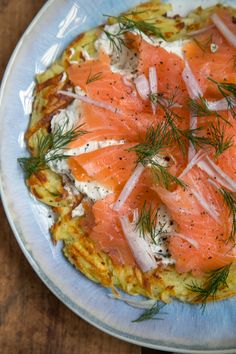 an omelet with salmon and cream cheese on it is sitting on a plate