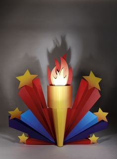 an open book with a lit candle in the middle and stars around it, on a gray background