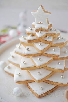 a white plate topped with cookies decorated like a christmas tree