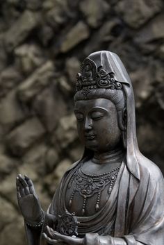 a statue of a buddha holding a bowl