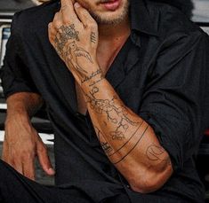 a man with many tattoos on his arm