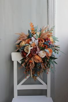 a bouquet of flowers sitting on top of a white chair