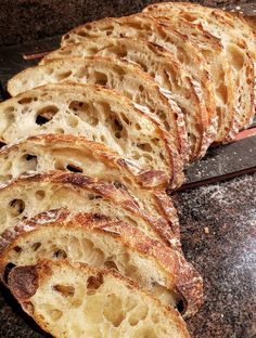 slices of bread sitting on top of a counter next to a knife and spatula