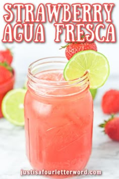 strawberry agua fresca in a mason jar with lime and strawberries