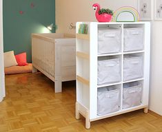 a baby's room with a white crib and wooden floors