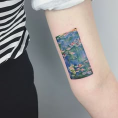 a woman's arm with a water lily tattoo on it