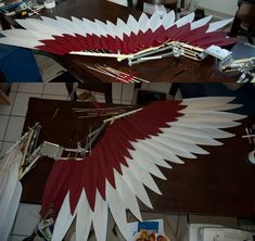 two large red and white kites sitting on top of a table