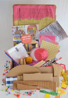 an open cardboard box filled with craft supplies