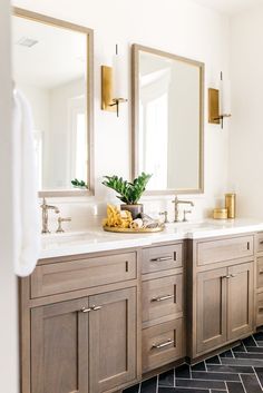 a bathroom with two sinks, mirrors and tiled flooring in black and white tile