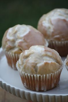 some muffins are sitting on a white plate