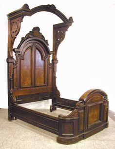 an antique wooden bed frame with carved details