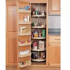 an open pantry door in a kitchen with lots of food on the shelves and cupboards