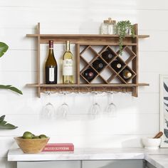 a wooden shelf holding wine glasses and bottles