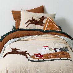 a bed with christmas decorations on it and a santa sleigh in the background