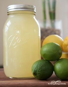 lemons and limes sit on a table next to a mason jar that says home - made catarade