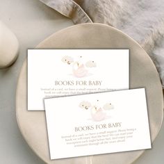 two books for baby cards sitting on top of a plate